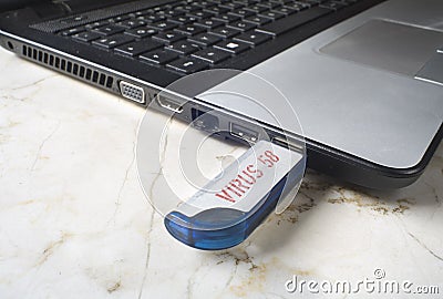 Infecting a laptop with a usb data stick Stock Photo