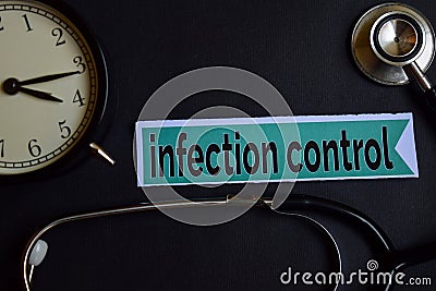 Infection Control on the print paper with Healthcare Concept Inspiration. alarm clock, Black stethoscope. Stock Photo