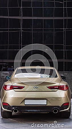 Infiniti Q60 coupe car, rear view. Goldish premium sports coupe with V6 engine Editorial Stock Photo