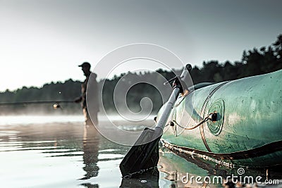 Inflatable boat on the lake at dawn, a fisherman at dawn fishing. Fishing hobby vacation concept. Copy space Stock Photo