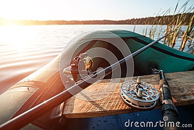 Inflatable boat on the lake at sunrise. Fishing hobby vacation concept. Copy space Stock Photo