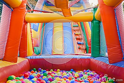 Inflatable castle full of colored balls for children to jump Stock Photo