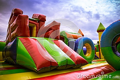 Inflatable castle labirynth slide in a playground against the blue sky Stock Photo