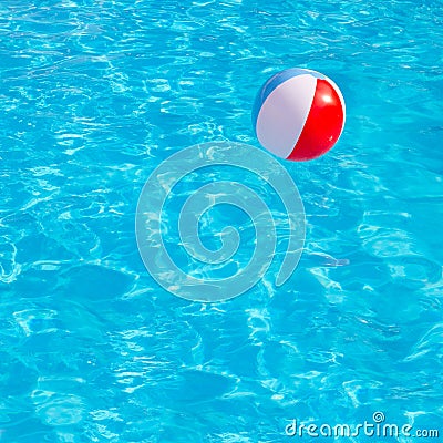 Inflatable colorful ball floating in swimming pool Stock Photo