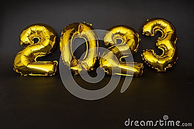 Inflatable golden balloons numbers 2023 on a yellow background. Happy New Year. Flat lay. Copy space. Christmas. Happy Stock Photo