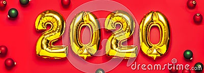 2020 inflatable golden numbers with red and green christmas balls on red background. New year winter decoration, holiday symbol, Stock Photo