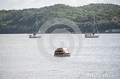 Inflatable lifeboat in waters Stock Photo