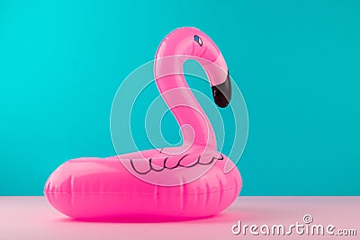 Inflatable mini flamingo on pastel blue and pink background. Pool float party, trendy summer concept. Flat lay, copy space. Stock Photo