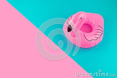 Inflatable mini flamingo on pastel blue and pink background. Pool float party, trendy summer concept. Flat lay, copy space. Stock Photo