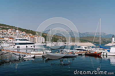 Inflatable motor boats stand next to yachts at the marina berths Stock Photo