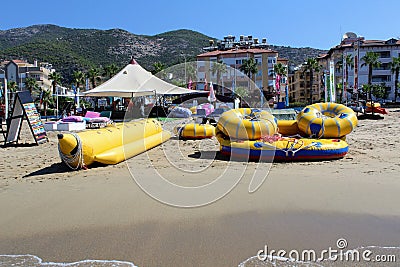 Inflatable rafts for entertainment of resting people lie on the sandy shore of the Mediterranean Sea Editorial Stock Photo