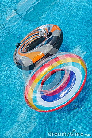 Inflatable water activities circles tuba float on the water in the pool. Concept, fun, perky summer and relaxation Stock Photo