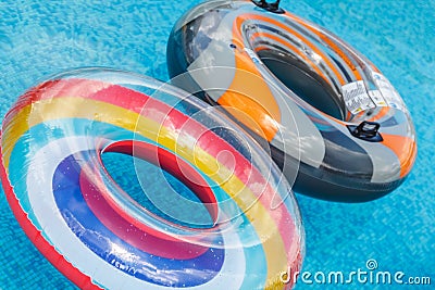 Inflatable water activities circles tuba float on the water in the pool. Concept, fun, perky summer and relaxation Stock Photo