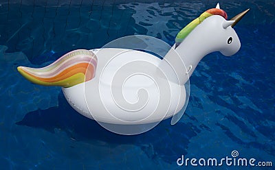 Inflatable white unicorn in the pool Stock Photo