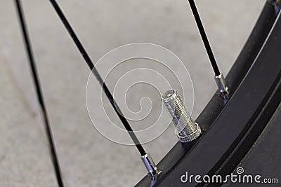 Inflate or Blow Up a Bicycle Tire. Uncovered stem valve on a bicycle. Stock Photo