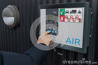 Inflates tire with air in service station. Flat tire concept. Punctured car tire. Editorial Stock Photo