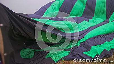 Inflating, unpack and flying up hot air balloon watermelon. Burner directing flame into envelope. Take off aircraft fly Stock Photo