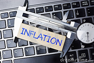 Inflation measurement concept with calliper tool on computer keyboard Stock Photo