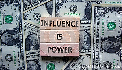 Influence is power symbol. Wooden blocks with words `Influence is power`. Beautiful background from dollar bills. Business, Stock Photo