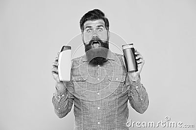 Influencer beauty blogger reviewing bath cosmetics. Bath soap. Bath cosmetics review. Man bearded hipster hold plastic Stock Photo