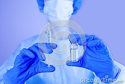 Influenza and coronavirus vaccination. Female doctor holds syringe and medical injection in hands. Stock Photo