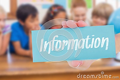 Information against cute pupils and teacher smiling at camera in classroom Stock Photo