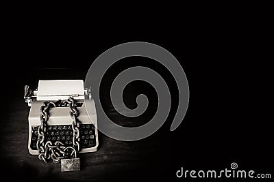 Information censorship - Typewriter locked with a chain Stock Photo