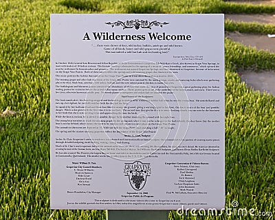 Information plaque and poem for `A Wilderness Welcome` by Archie Saint Clair in the historic district of Grapevine Editorial Stock Photo