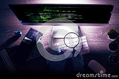 Informational system hacking concept with unrecognisable hacker with gloves in front on the computer on the night Stock Photo