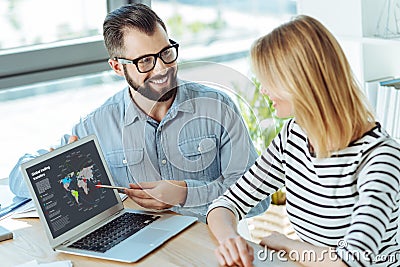 Smiling man giving a presentation to his female colleague Stock Photo