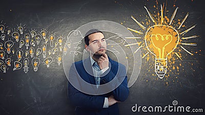 Ingenious businessman gathering ideas as joining all the lightbulbs into one big and bright bulb. Genius creativity and positive Stock Photo