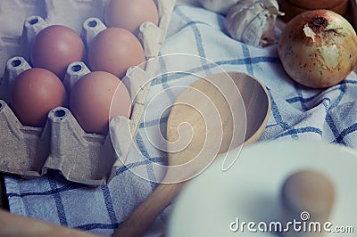 Ingredient in the kitchen with sunlight from the window. Close up view of ingredients of fried egg and vintage pot. Stock Photo