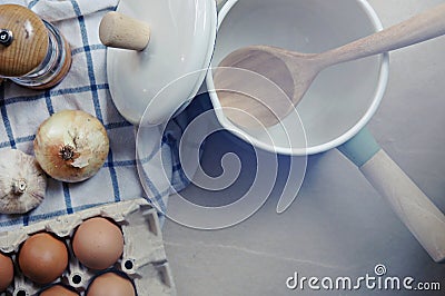 Ingredient in the kitchen with sunlight from the window. Close up view of ingredients of fried egg and vintage pot. Stock Photo