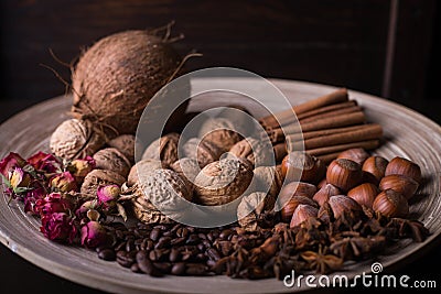 ingredients for baking, cinnamon sticks, star anise, cloves, nuts, coconut, coffee beans on a wooden background Stock Photo