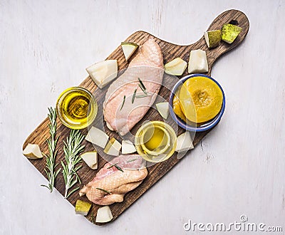 Ingredients for cooking duck breast with fruit, herbs and honey wooden rustic cutting board top view close up Stock Photo