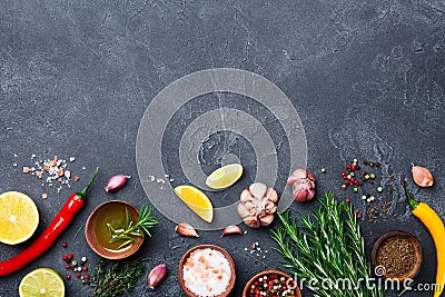 Ingredients for cooking. Herbs and spices on black stone table top view. Food background. Stock Photo
