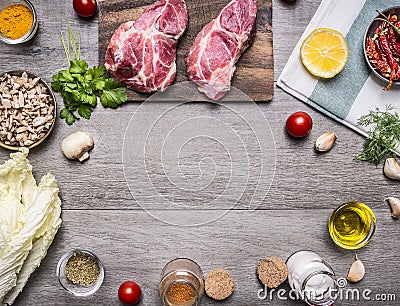 Ingredients for cooking pork steak with vegetables, fruits, spices, laid out by frame,place text on wooden rustic background Stock Photo