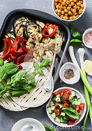 Ingredients for cooking summer grilled garden vegetables and spicy chickpeas vegetarian tortillas on grey background, top view. He Stock Photo