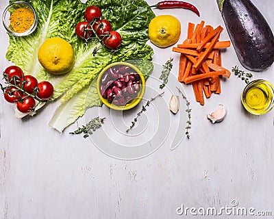 Ingredients for cooking vegetarian food, squash, beans, tomatoes on a branch, lemon, lettuce, sliced carrots border, place for te Stock Photo