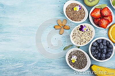 Ingredients for a healthy breakfast, nuts, oatmeal, honey, berries, fruits, blueberry, orange, Edible flowers, Chia Stock Photo