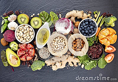 Ingredients for the healthy foods selection. The concept of healthy food set up on dark stone background Stock Photo