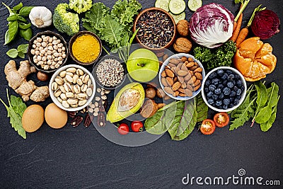 Ingredients for the healthy foods selection. The concept of healthy food set up on dark stone background Stock Photo