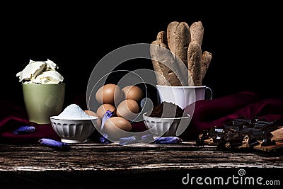 Ingredients for Italian tiramisu, chocolate, coffee and mascarpone on a black background Stock Photo