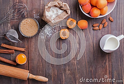 Ingredients and items for making a pie with apricots on the wooden background Stock Photo