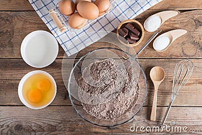 Ingredients for making cake chocolate on a wooden background. Stock Photo