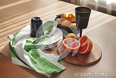 Ingredients for making lemonade. Fresh citrus fruits lemon and grapefruit, black glass and bottle on wooden shadow and light table Stock Photo