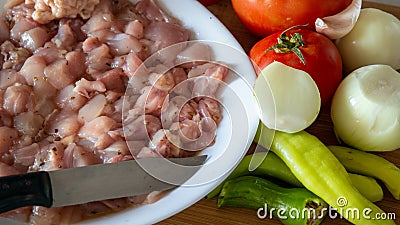 Ingredients prepared for chicken dinner. chopped chicken meat, tomatoes, peppers, onions and garlic Stock Photo
