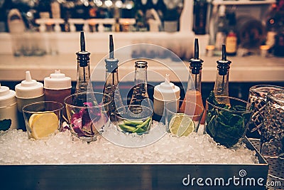 Ingredients and syrups for cocktails at bar counter in the the nightclub. Stock Photo