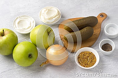 Ingredients for a traditional Polish salad: apples, pickles, onions, mayonnaise, sour cream or yogurt, mustard, salt Stock Photo