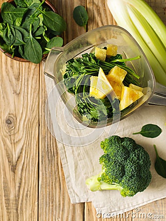 Ingrediets for green smoothie - parsley, spinach, broccoli and celery on wooden table Stock Photo